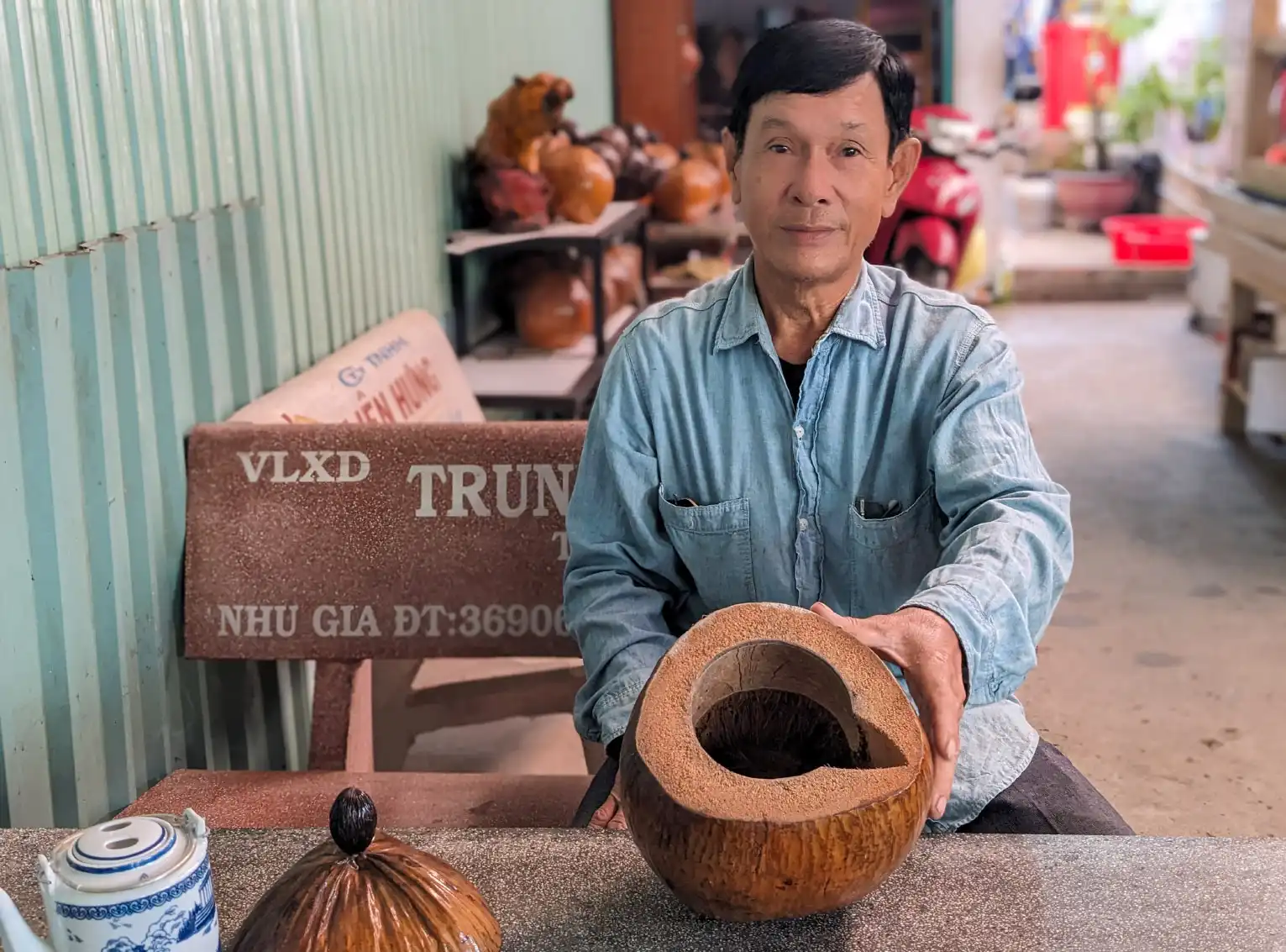 The old farmer is passionate about making teapots from dried coconuts